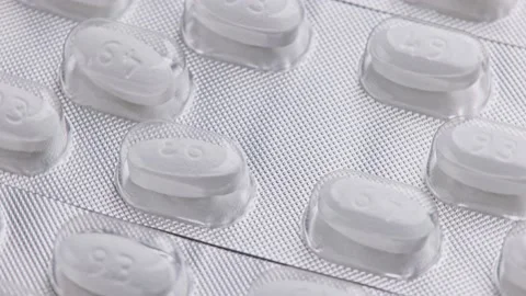 White tablet oval tablets blisters close-up looped spinning or rotating macro Stock Footage 163654492