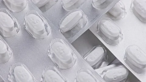 White tablet oval tablets blisters close-up looped spinning or rotating macro Stock Footage 163835327