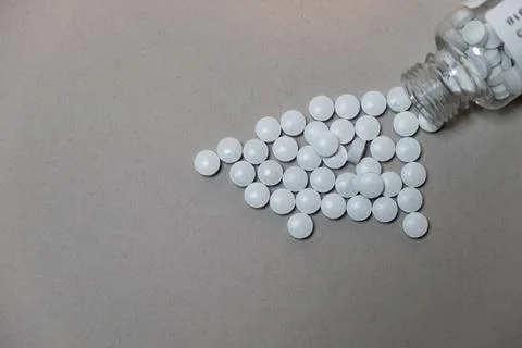 White tablet pills on a flat background with copy space. For advertising and  Stock Photos