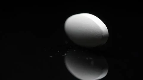 White tablet with a reflection on a black background. The concept of medication Stock Photos