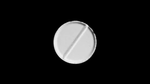 White tablet rotates on black background. Pharma industry. Healthcare concept. Video stock 297255257