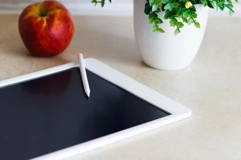White tablet on the table, blurred background Stock Photos