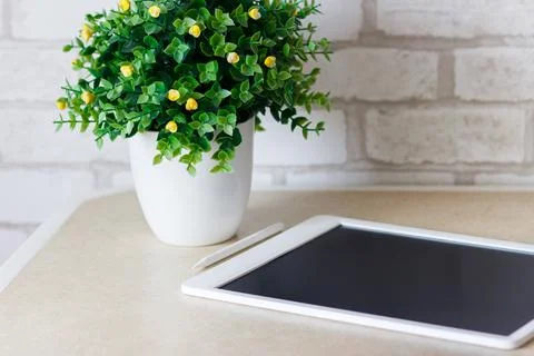 White tablet on the table, blurred background Foto stock