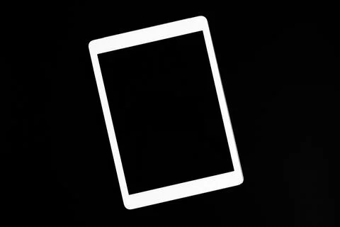 White tablet turned off on a black background. minimal black white concept. s Stock Photos