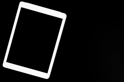 White tablet turned off on a black background. minimal black white concept. s Stock Photos