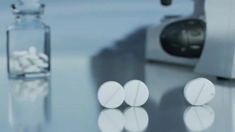 White tablets are rolling across a pharmacist's desk. 3d rendering Stock Footage 295045073