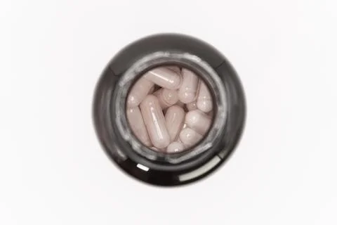 White tablets in a black jar, top view, medicines for diseases, dietary Stock Photos
