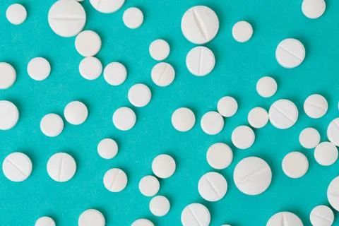 White  tablets on blue  background - Image Stock Photos