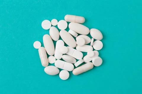 White  tablets on blue  background - Image Stock Photos