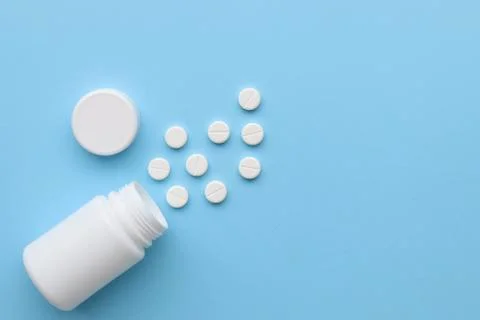 White tablets on a blue background, space for text Stock Photos