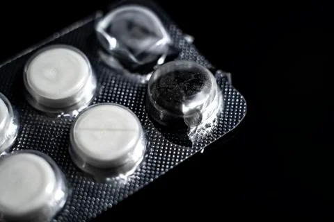 White tablets close up on a black background macro photo. Stock Photos