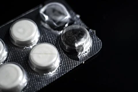 White tablets close up on a black background macro photo. Stock Photos
