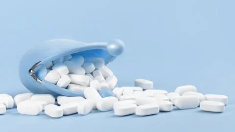 White tablets falling out of blue purse, drugs and medicine Stock Photos