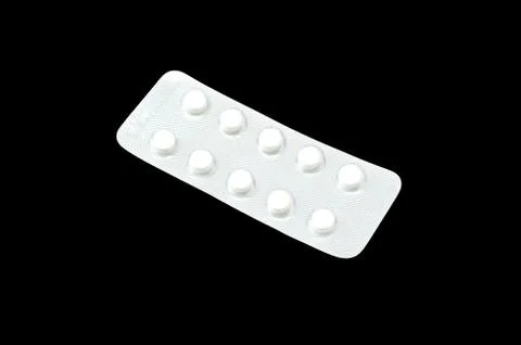 White tablets isolated on black background Foto stock