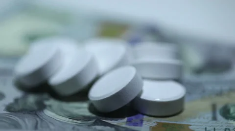 White tablets on money in rotation Stockbeeldmateriaal 35824651