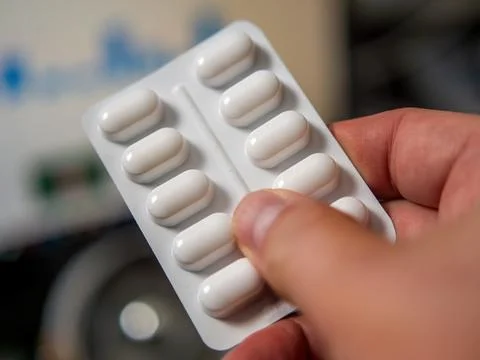White Tablets Packaging in Hand Stock Photos