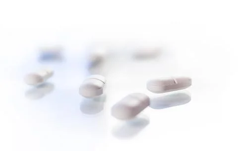 White tablets on reflective surface Stock Photos
