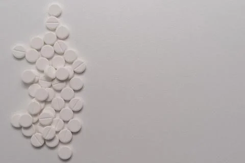 White tablets scattered on a white background Stock Photos