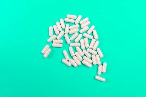White tablets on a turquoise background. isolate Stock Photos