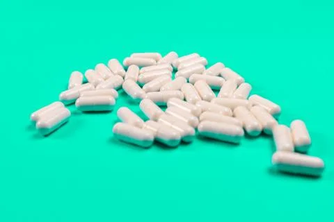White tablets on a turquoise background. isolate Stock Photos