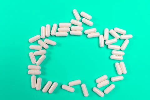 White tablets on a turquoise background. isolate Stock Photos