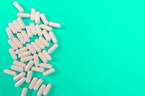 White tablets on a turquoise background. isolate Stock Photos