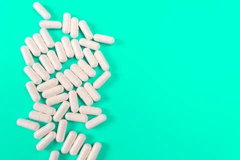 White tablets on a turquoise background. isolate Stock Photos