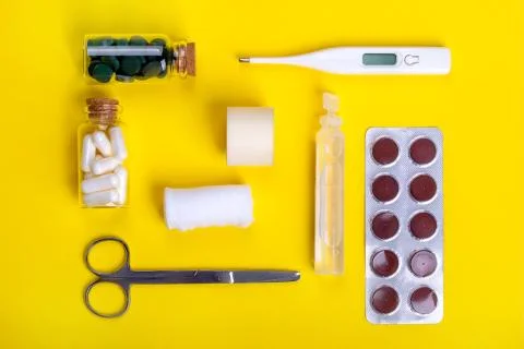 White tablets on the yellow background Stock Photos
