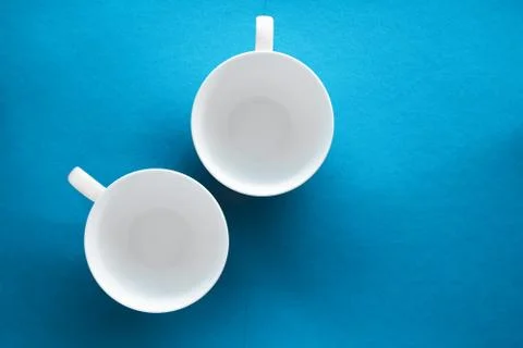 White tableware crockery set, empty cup on blue flatlay background Stock Photos