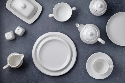 White tableware for serving and eating meals. Empty clean plates, cup, teap.. Stock Photos