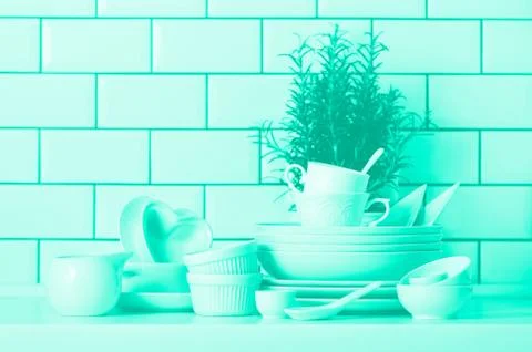 White tableware for serving. Dishes, cups, spoons, utensils and other different Stock Photos