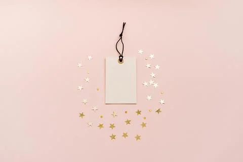 White tag with a black string is placed in the center, surrounded by gold s.. Stock Photos