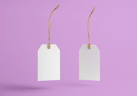 White tag with string on a pink background Stock Photos