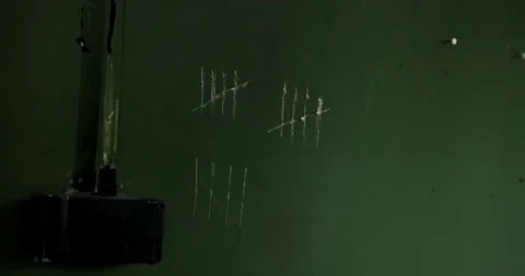 White tally stroke counting marks jail wall scratch Close-up of a finger tracing Stock Footage 219246032