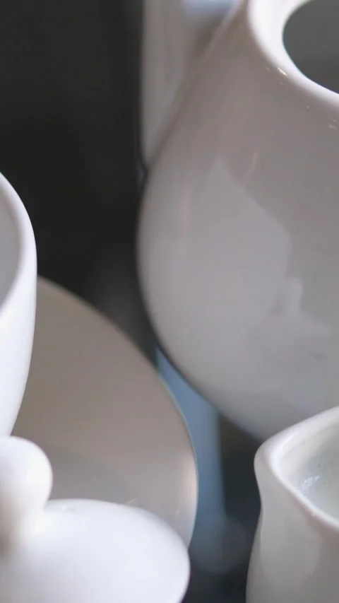 White tea ceremony utensils mug milk jug teapot teapot with lid saucers and cup Stock Footage 302079665