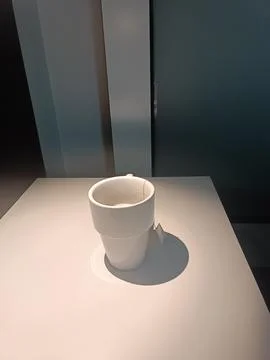 White tea cup on the table under the light with tea bag in it Stock Photos