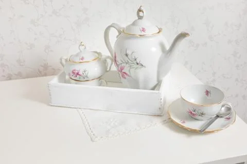 White tea service on white commode ready for use on tray. Start a morning wit Stock Photos
