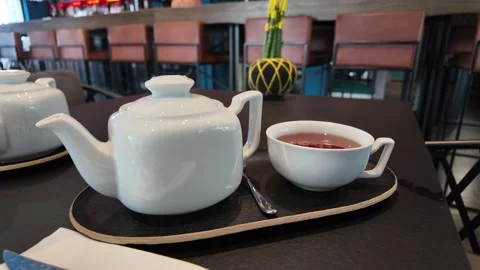 A white tea set with steaming tea cup. Stock Footage 317628818