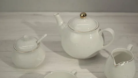 White Tea Set on Transparent Placemat on Light Wood Table Stock Footage 268111603