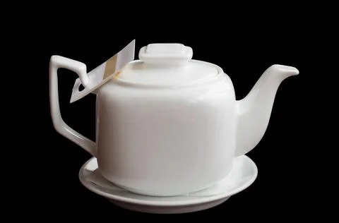 White teapot on a black background Stock Photos