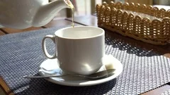 https://images.pond5.com/white-teapot-pouring-tea-cup-footage-080789229_iconm.jpeg