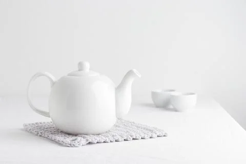 White teapot on a table Stock Photos