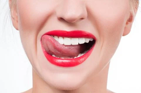 White teeth and red lips. Perfect female smile after bleaching. Dental care a 写真素材
