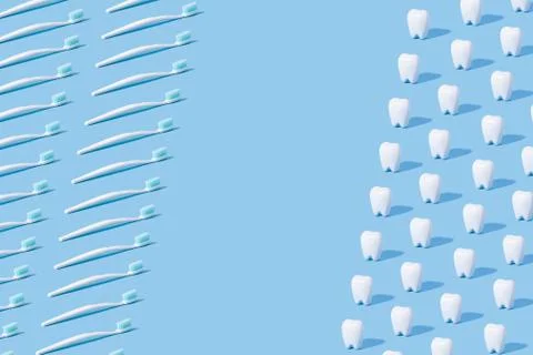 White teeth and toothbrush pattern on a blue paper background. Stock Photos