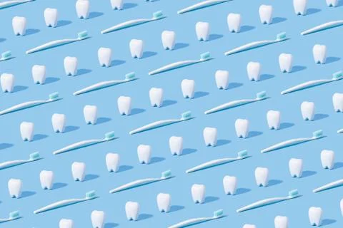 White teeth and toothbrush pattern on a blue paper background. Stock Photos