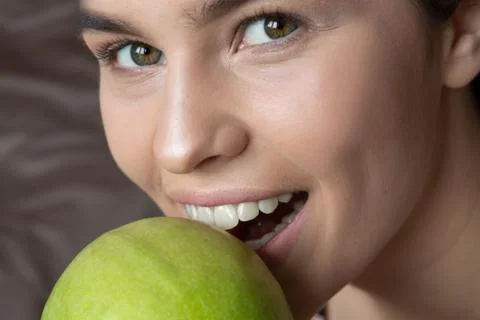 White Teeth Bitten off Green Apple. Medical Concept. Health and beauty Stock Photos