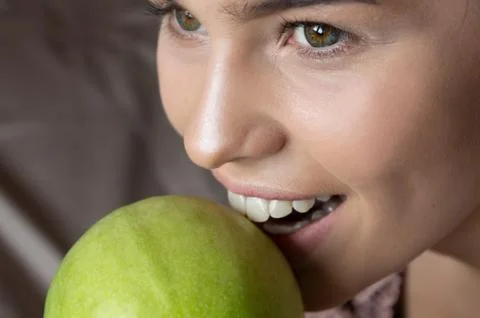 White Teeth Bitten off Green Apple. Medical Concept. Health and beauty Stock Photos