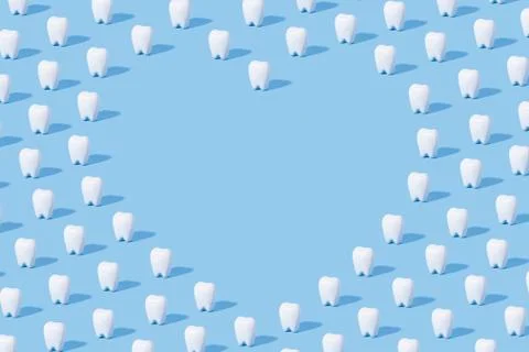 White teeth pattern on a blue paper background with text place. Stock Photos