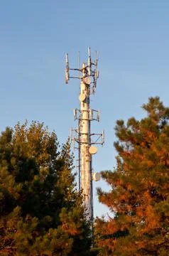 White Telecom Tower with Trees and Blue Sky Stock Photos
