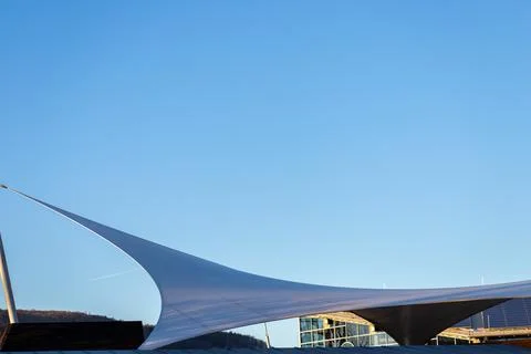 White tensile canopy structure against clear blue sky Stock Photos